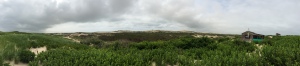 A panoramic view of the dunes in Truro, including a dune shack.
